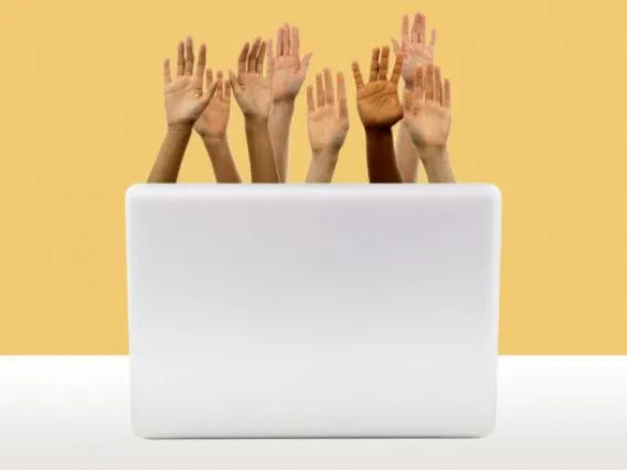 Hands raised out of a laptop