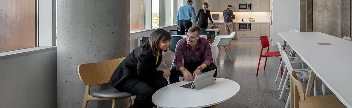 Supervisor with new employee in a break room